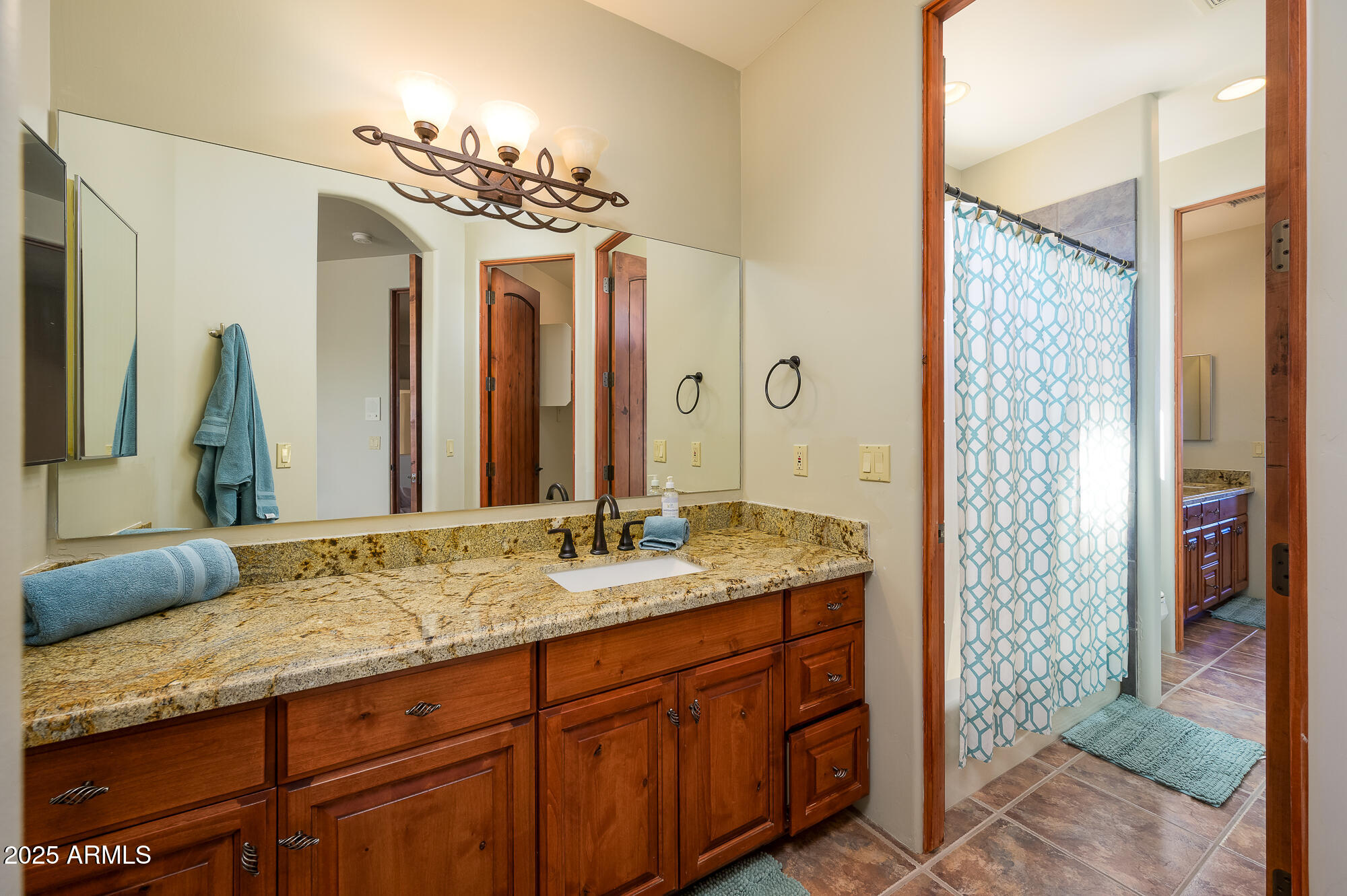 8540 East McDowell Road, Unit 29 Mesa, AZ 85207 - Photo 28 of 59 a bathroom with a granite countertop sink a mirror and a shower