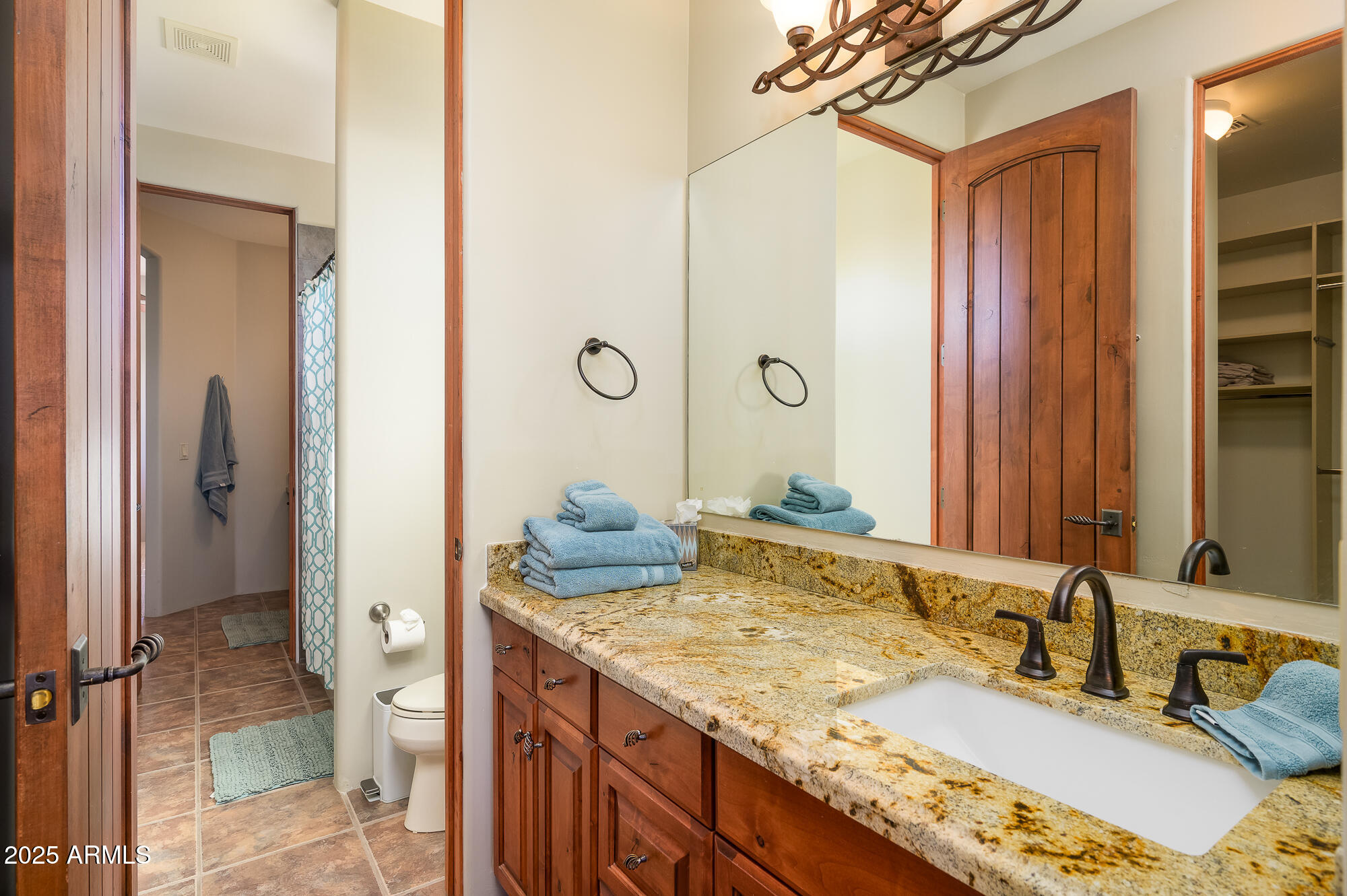 8540 East McDowell Road, Unit 29 Mesa, AZ 85207 - Photo 30 of 59 a bathroom with a granite countertop sink and a mirror
