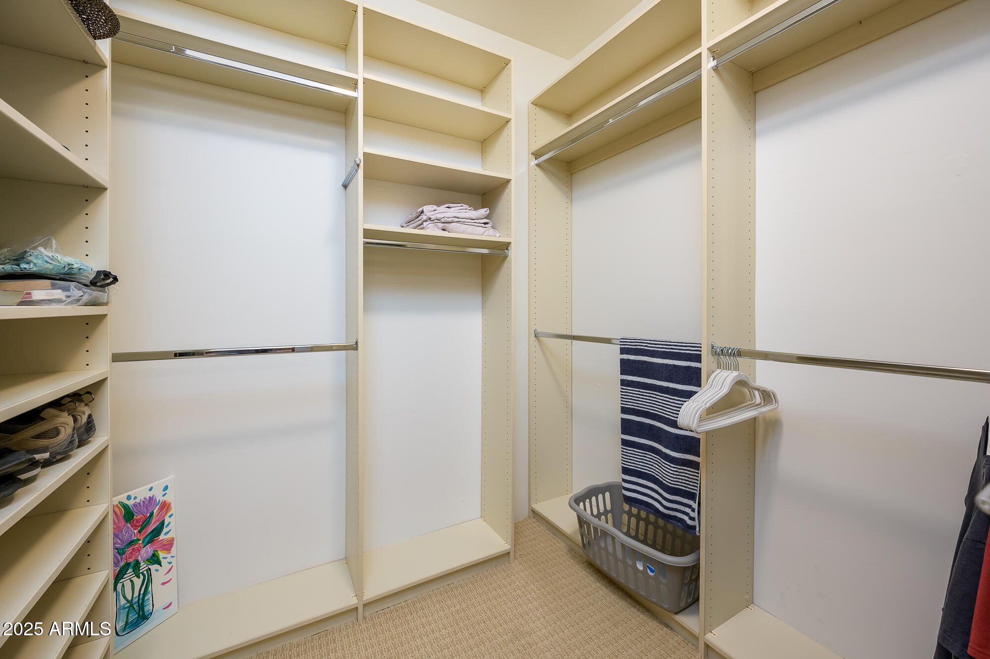 8540 East McDowell Road, Unit 29 Mesa, AZ 85207 - Photo 31 of 59 a view of walk in closet with clothes and shoes