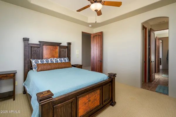 a bed room with a bed and a chandelier