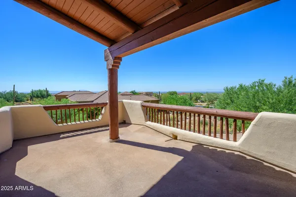 a view of an outdoor dining space with furniture and garden view