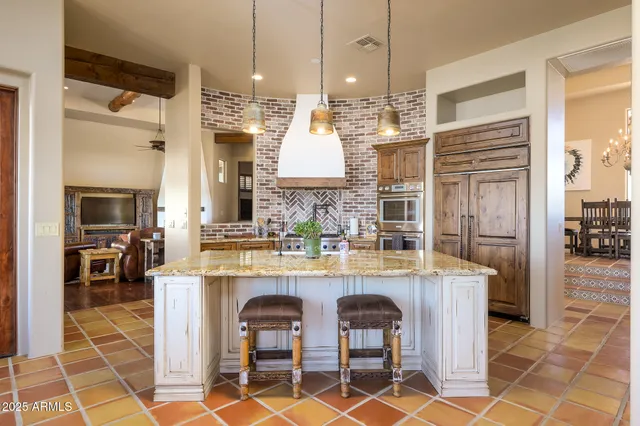 a kitchen with cabinets and chairs