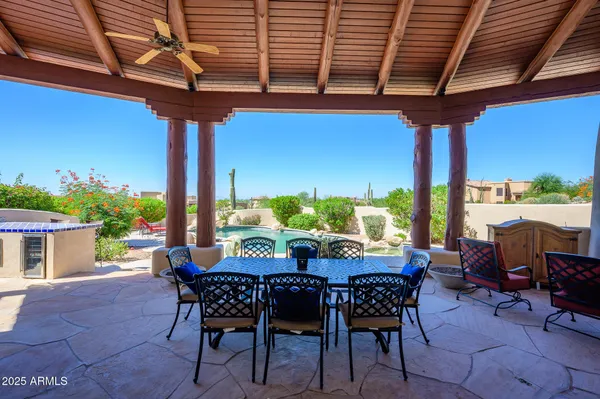 a swimming pool with outdoor seating and yard