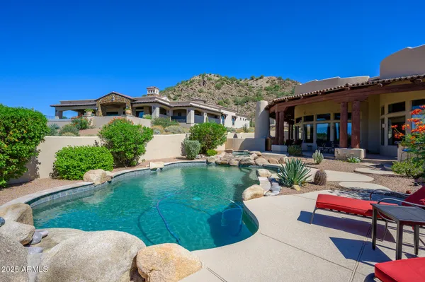 a roof deck with table and chairs