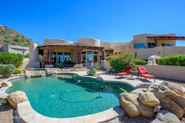 a view of a patio with furniture and a backyard