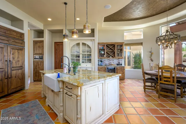 a view of a dining room with furniture a chandelier and wooden floor