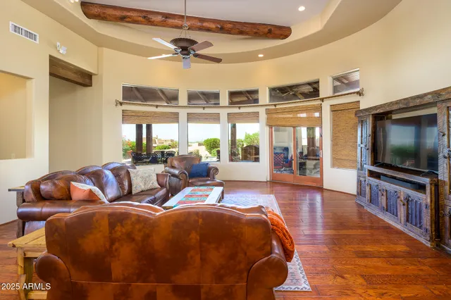 a living room with furniture fireplace and wooden floor
