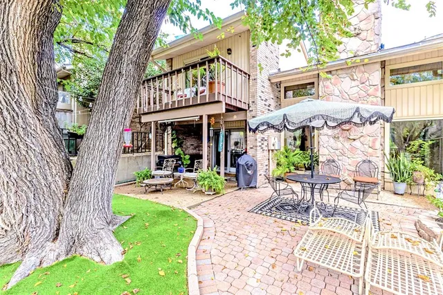 a view of a chairs and table in patio with a fire pit