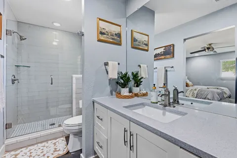 a bathroom with a sink a toilet and shower