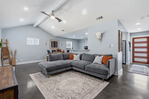 a living room with furniture and a rug