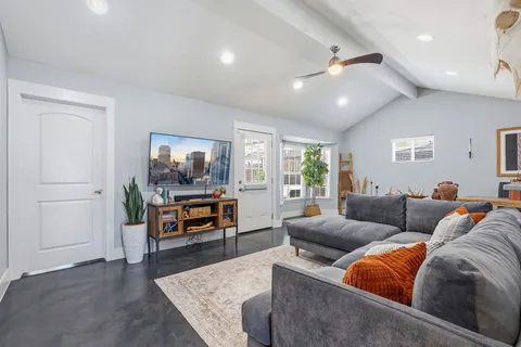 a living room with furniture and a flat screen tv