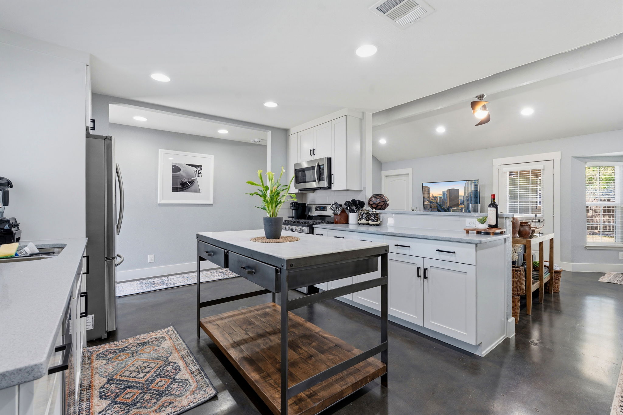 805 Nile Street Austin, TX 78702 - Photo 5 of 22 a kitchen with a table chairs refrigerator and microwave
