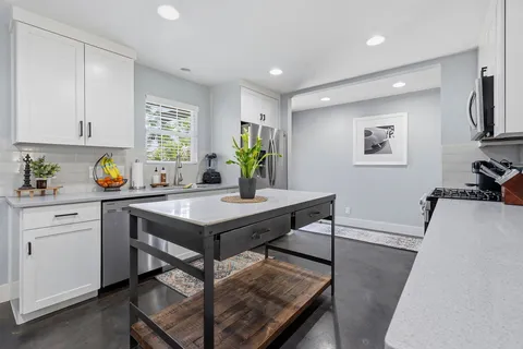 a kitchen with a table and chairs in it