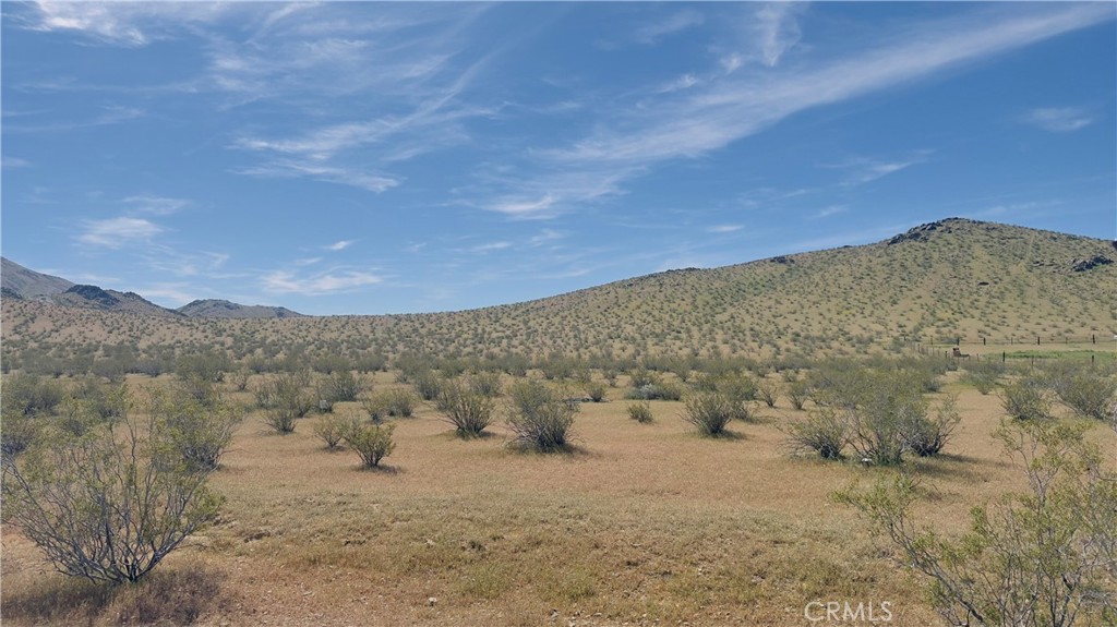 0 Near Caspar Road Apple Valley, CA 92307 - Photo 4 of 7 a view of a dry yard with mountains in the background