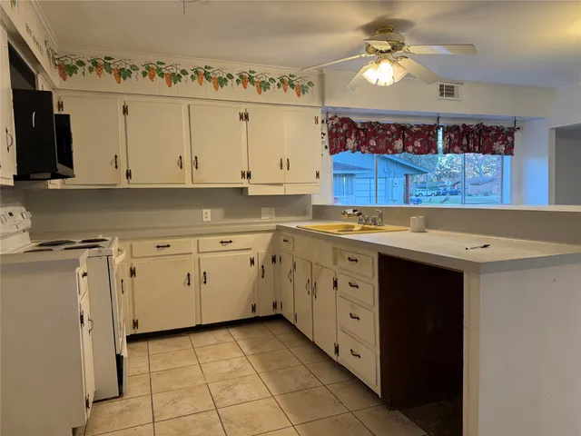 a kitchen with cabinets appliances and a counter top