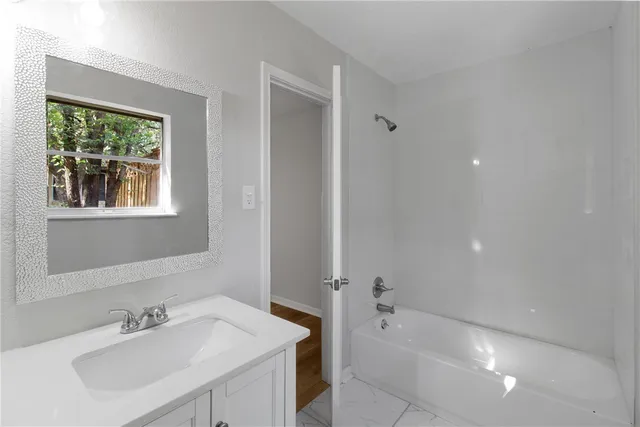 a bathroom with a sink toilet and a mirror