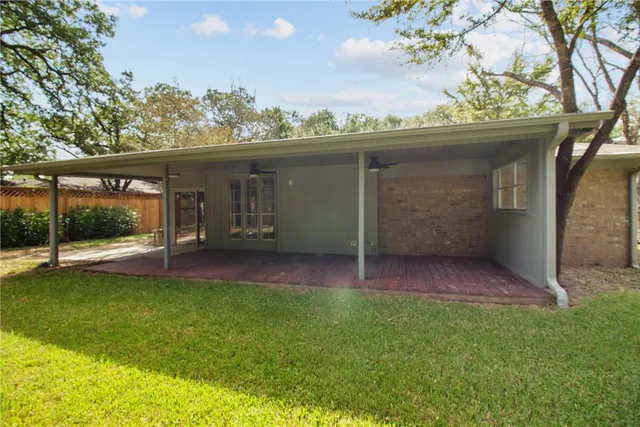 a view of a backyard with a garden and tree