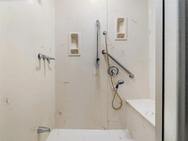 a bathroom with a glass shower door