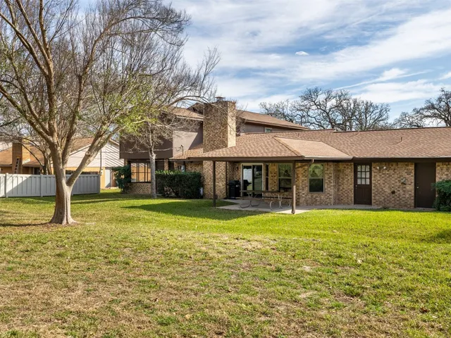 a view of a house with swimming pool and a yard