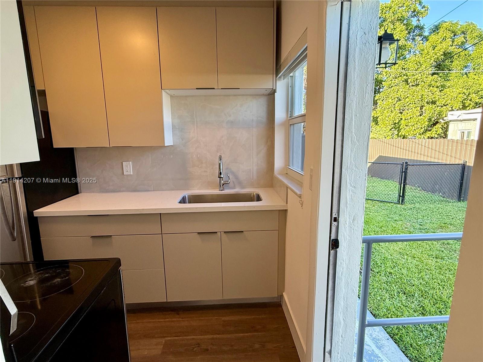 117 Northwest 118th Street, Unit 117 Miami, FL 33168 - Photo 12 of 20 a kitchen with a sink and a refrigerator