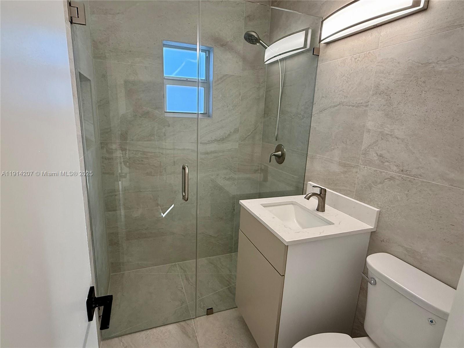 117 Northwest 118th Street, Unit 117 Miami, FL 33168 - Photo 15 of 20 a bathroom with a sink toilet and shower