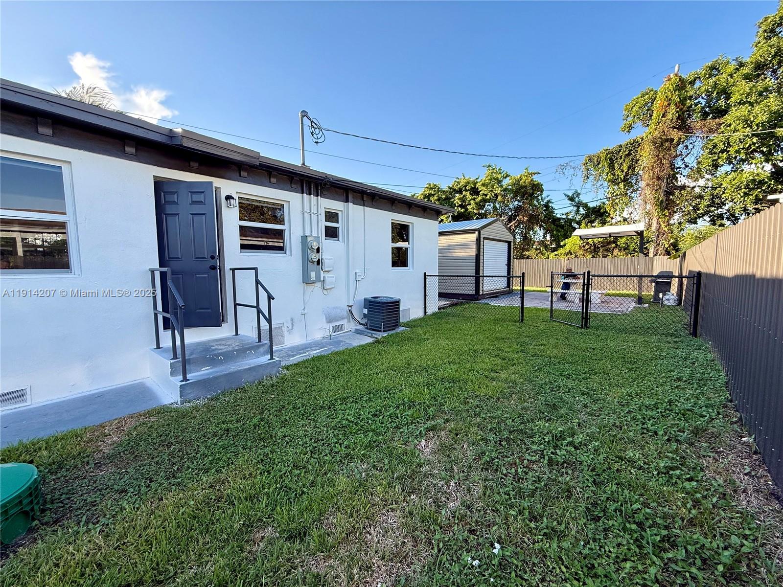 117 Northwest 118th Street, Unit 117 Miami, FL 33168 - Photo 18 of 20 a view of a house with a backyard