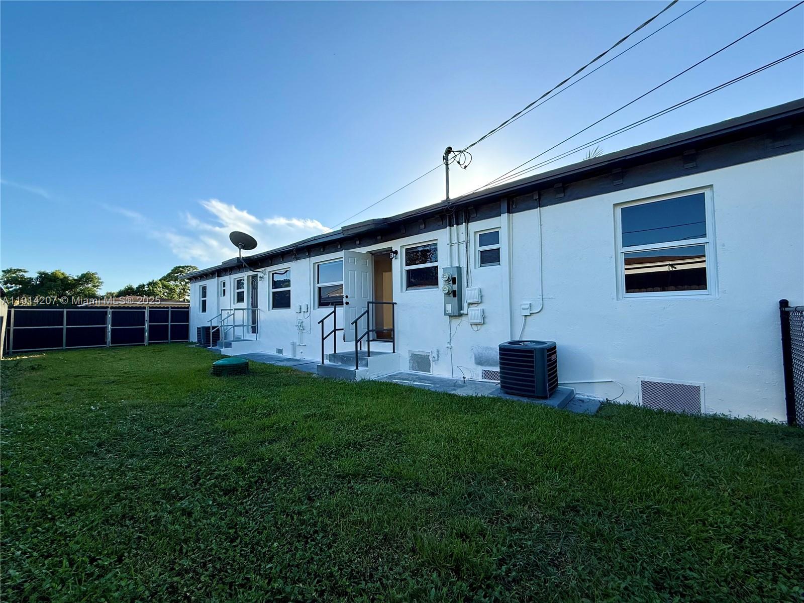 117 Northwest 118th Street, Unit 117 Miami, FL 33168 - Photo 19 of 20 a front view of house with yard and patio