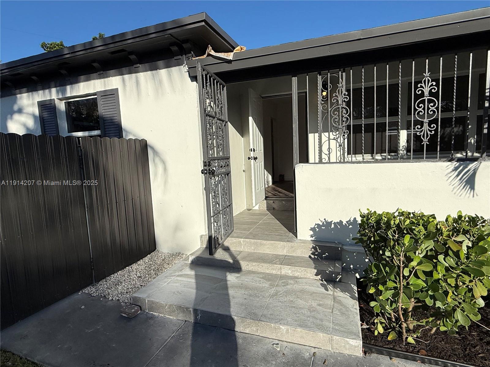 117 Northwest 118th Street, Unit 117 Miami, FL 33168 - Photo 2 of 20 a front view of a house with garden