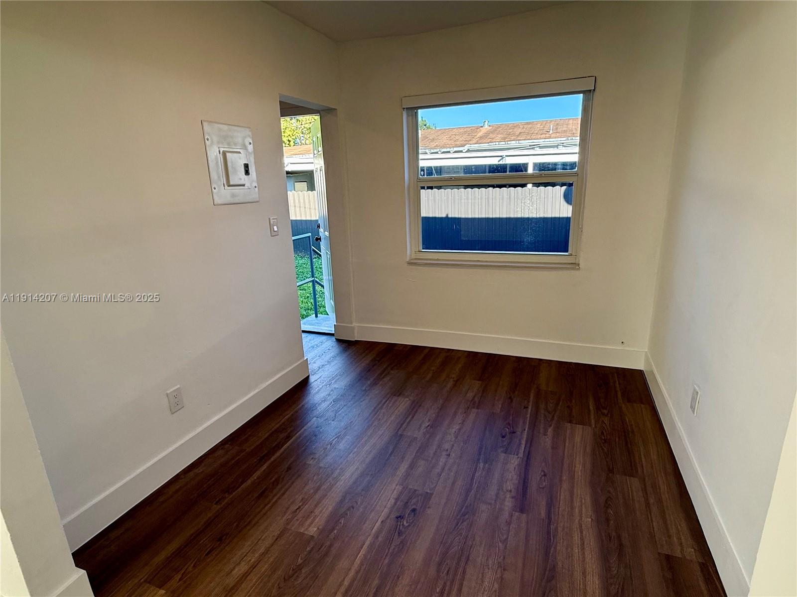 117 Northwest 118th Street, Unit 117 Miami, FL 33168 - Photo 8 of 20 a view of a hallway with wooden floor and a window