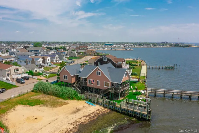 an aerial view of a house with a garden and lake view