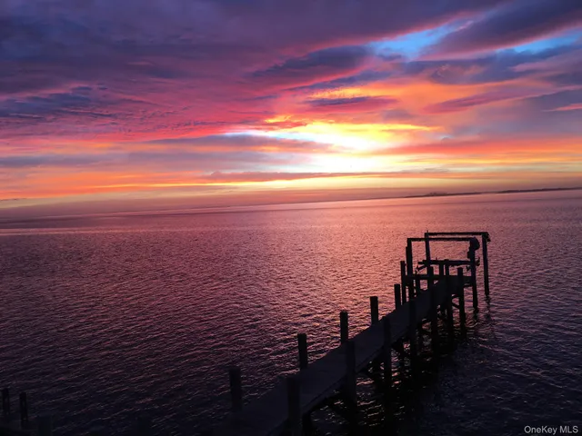 a view of a patio with table and chairs potted plants with wooden fence