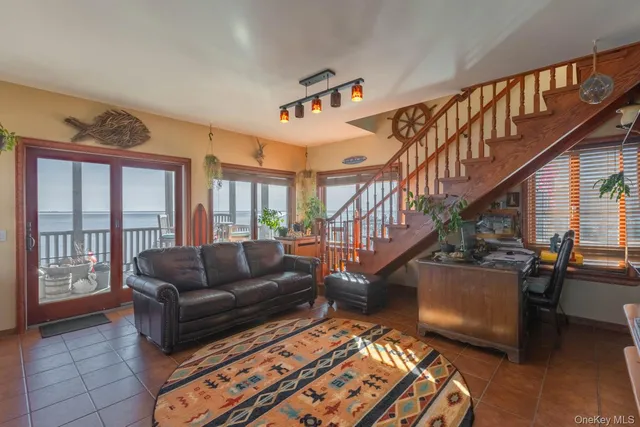 a living room with furniture and a dining table