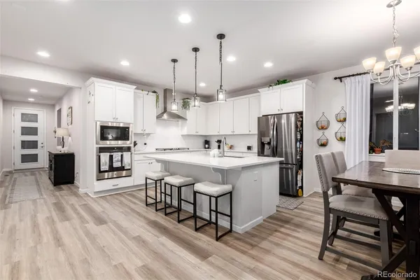 a kitchen with a sink appliances and cabinets