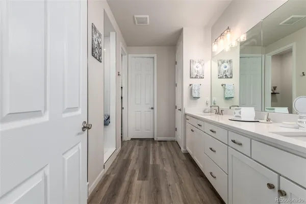 a spacious bathroom with a double vanity sink and a mirror