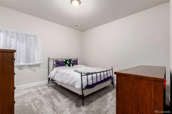 a bed sitting in a room next to a window