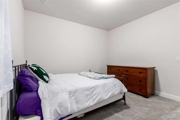 a bedroom with a bed and a dresser