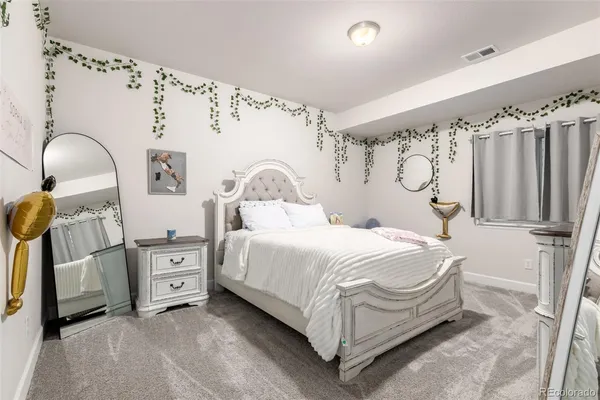 a bedroom with a bed and a mirror