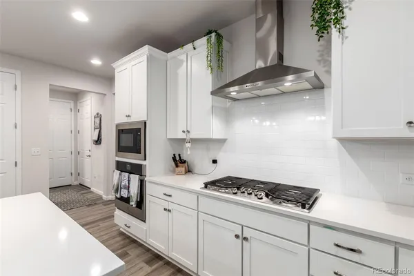 a kitchen with cabinets and a stove