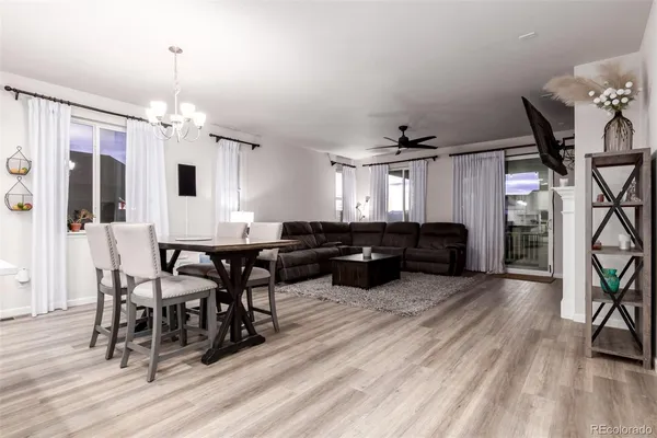 a living room with furniture dining table and a fireplace