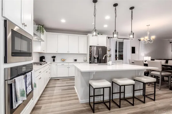 a large white kitchen with lots of counter space and window