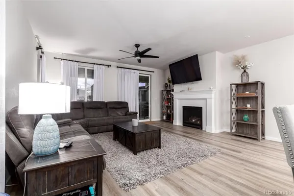 a living room with furniture a flat screen tv and a fireplace