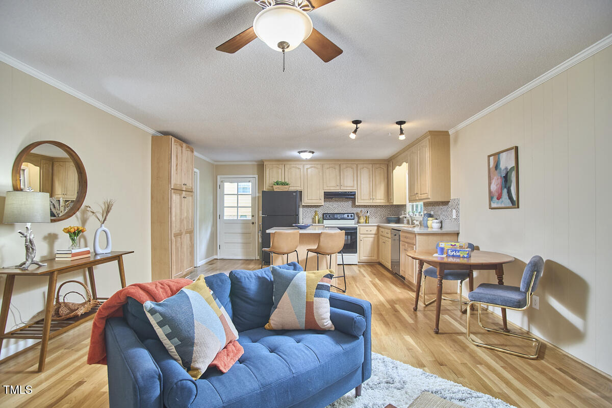 5319 Memory Lane Durham, NC 27712 - Photo 14 of 29 a living room with furniture kitchen view and a wooden floor