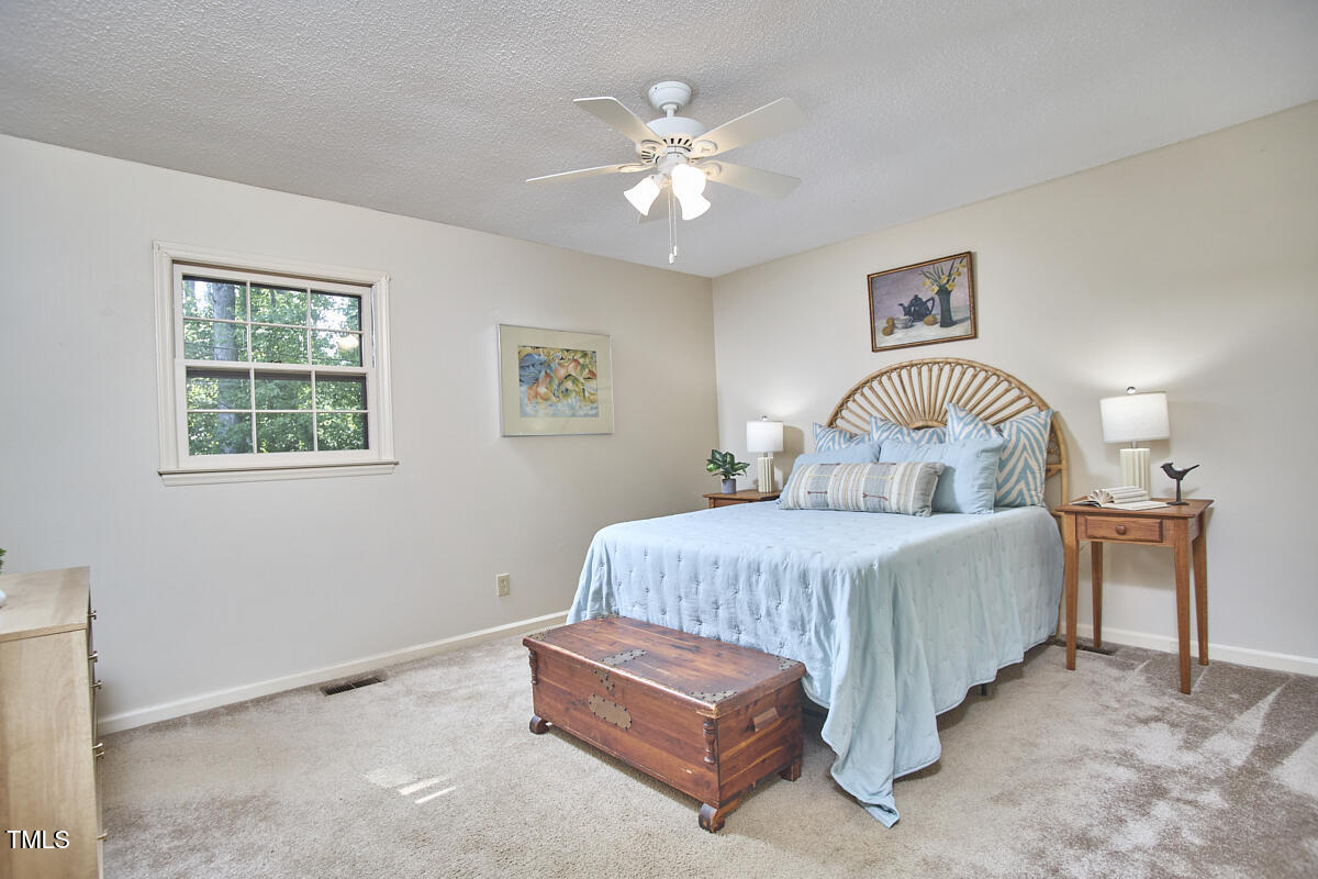 5319 Memory Lane Durham, NC 27712 - Photo 16 of 29 a bedroom with a bed window and couch