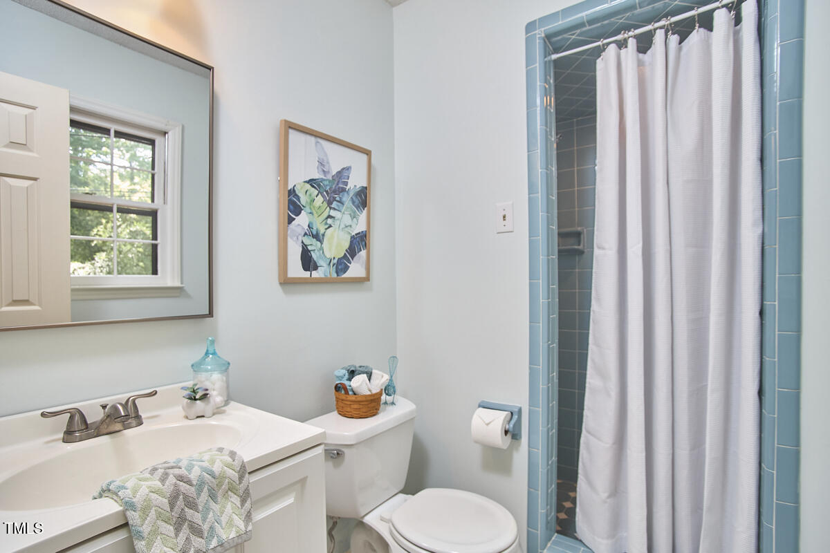 5319 Memory Lane Durham, NC 27712 - Photo 18 of 29 a bathroom with a sink toilet and window