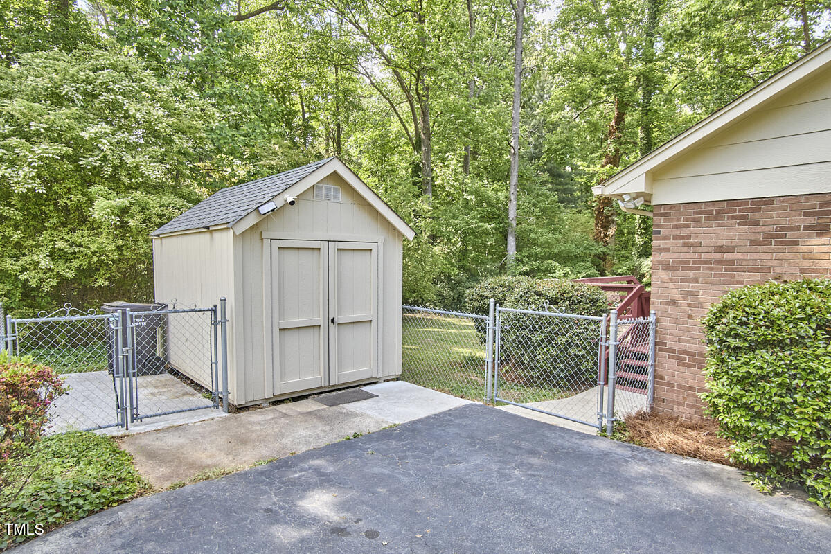 5319 Memory Lane Durham, NC 27712 - Photo 25 of 29 a view of a small house with a yard and fence