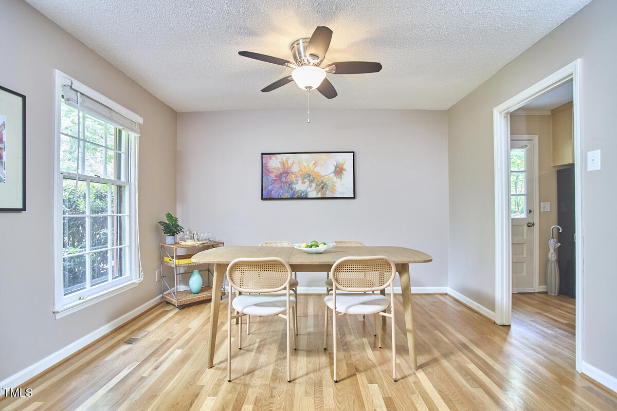 5319 Memory Lane Durham, NC 27712 - Photo 7 of 29 a view of a dining room with furniture a chandelier and wooden floor