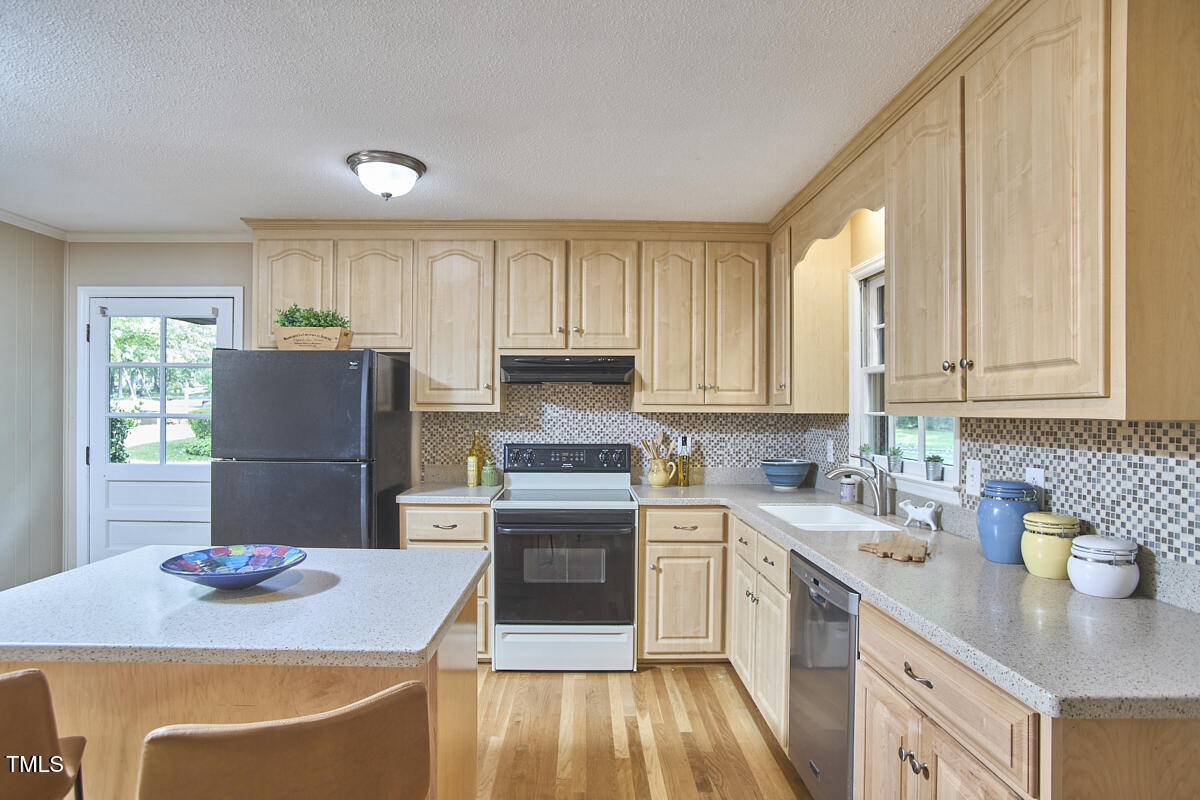 5319 Memory Lane Durham, NC 27712 - Photo 10 of 29 a kitchen with stainless steel appliances granite countertop a sink stove and refrigerator