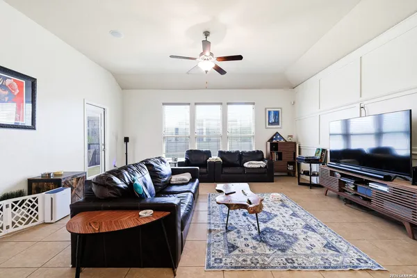 a living room with furniture a rug and a flat screen tv