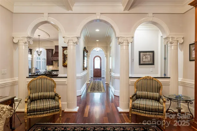 a view of a hallway with furniture and wooden floor