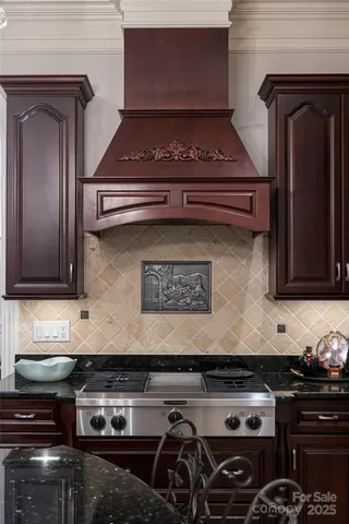 a stove top oven sitting inside of a kitchen